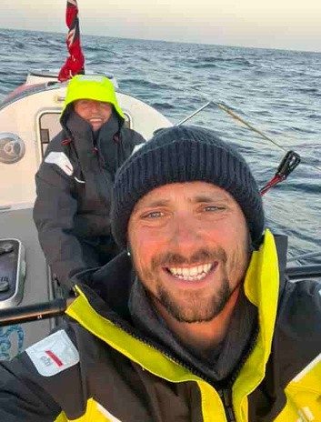 A member of the crew at sea, wrapped up against the cold