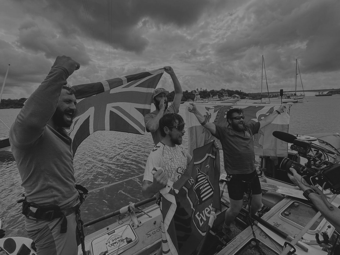 The Ocean Revival crew with a Union Jack, in black and white