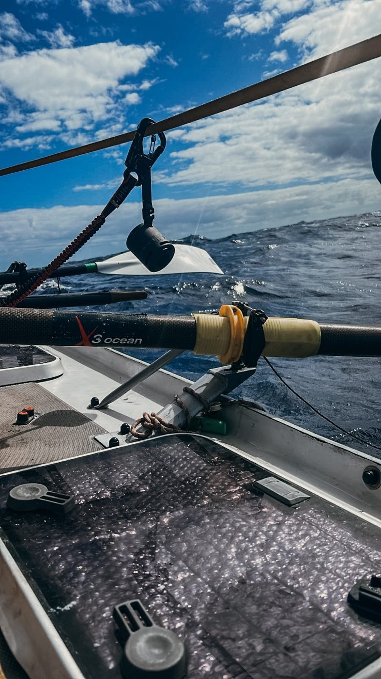 Oars and rigging of the ocean rowing boat over dark water